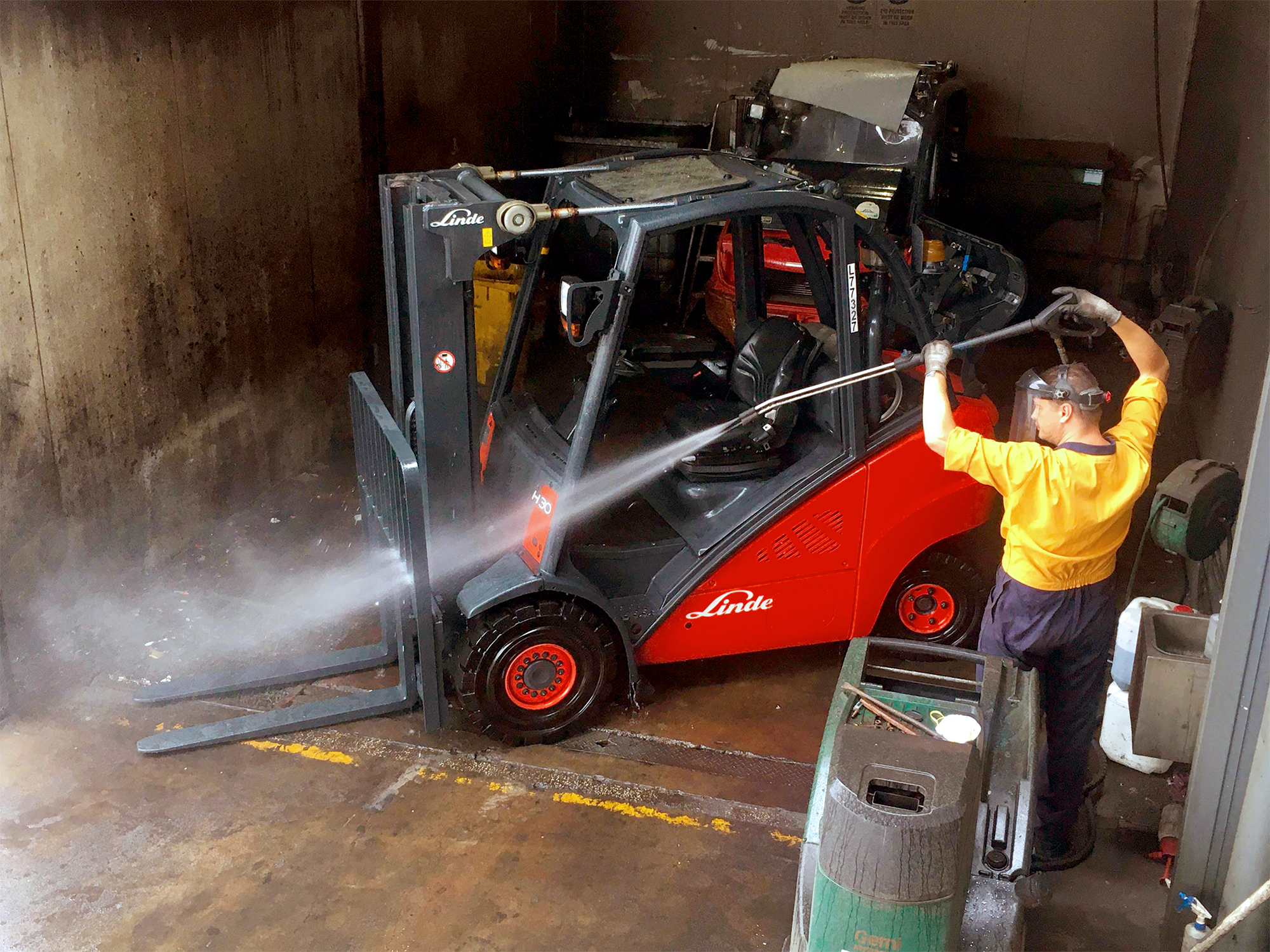 Man washing forklift