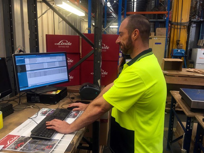 Linde warehouse manager at computer